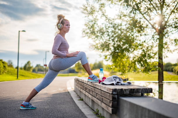 istock Woman stretching her leg at the bench 1392143790