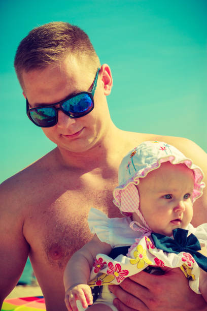 istock Man posing with baby on summer 1392143808