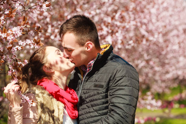 istock Couple in love walking in park at sunny spring day 1392143890