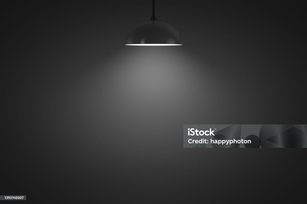 Hanging lamp glows in a dark room Hanging lamp glows in a dark room. Copy space. Design element. Darkroom Stock Photo