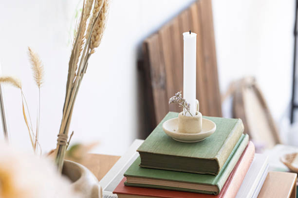 istock Old book and candle in an candlestick 1392150687