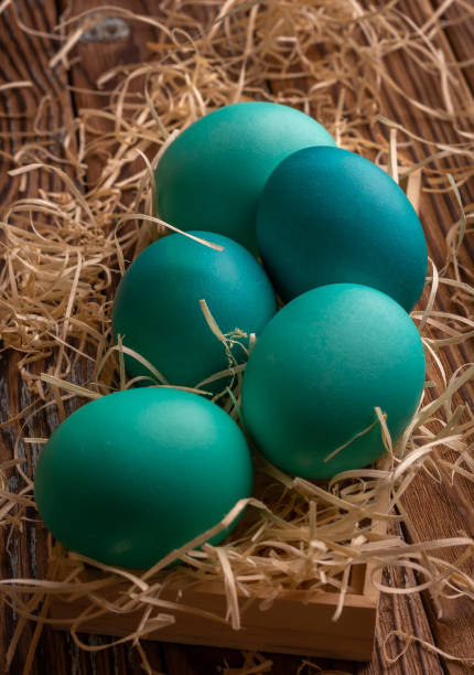 istock Colorful easter eggs on hay. Bright and colorful eggs 1392150691