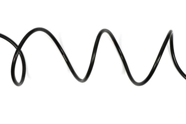 Part of black hair elastic made of glossy silicone in the form of a spiral macro shot on a white background top view. High quality photo