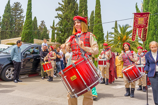 Lugo, Spain- October 10, 2021: Folk  musician wearing traditional clothing , playing drum in a narrow pedestrian  street during San Froilán annual celebrations, traditional festival in Lugo city Galicia, Spain.