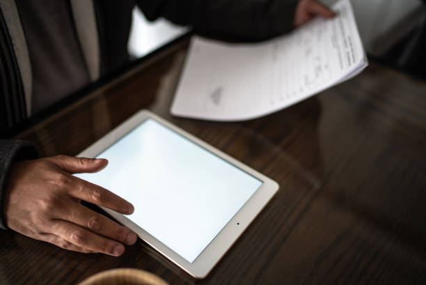 istock Mid adult man working at home while use digital tablet 1392154077