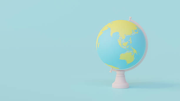 istock Yellow and blue globe on pink stand. Designed in pastel tones. 1392157243