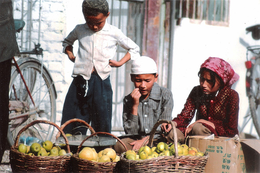 In Xinjiang, the great market is called Bazaar.Unlike ordinary market,Bazaar usually runs one day a week.Every city, county and township has Bazaar.orchardist who sell apple in Yutian Bazaar.Film was photo on  November 29,1996, in the Kashgar, Xinjiang, China