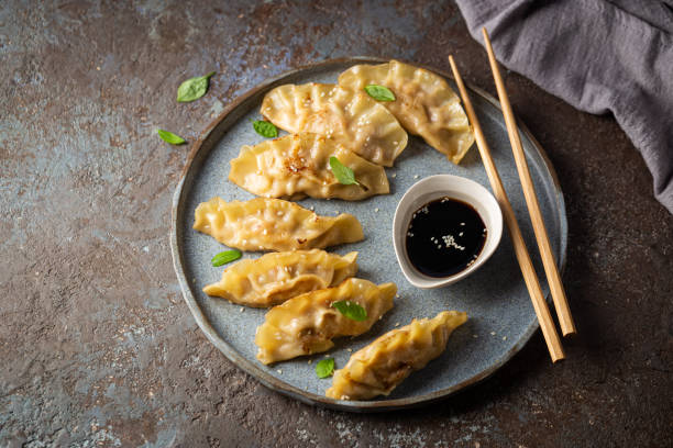 istock Asian dumplings with soy sauce 1392157971