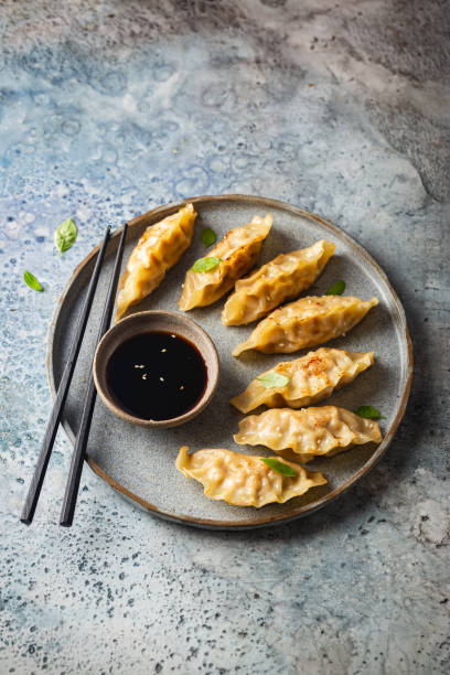 istock Asian dumplings with soy sauce 1392157973