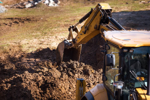 istock Wheel excavator loader is digging the soil at the construction site. 1392159927