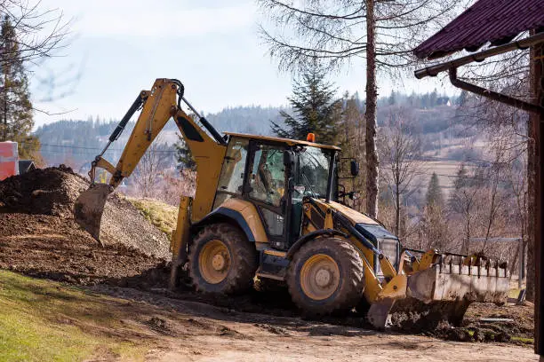 Photo of Wheel excavator loader is digging the soil at the construction site.