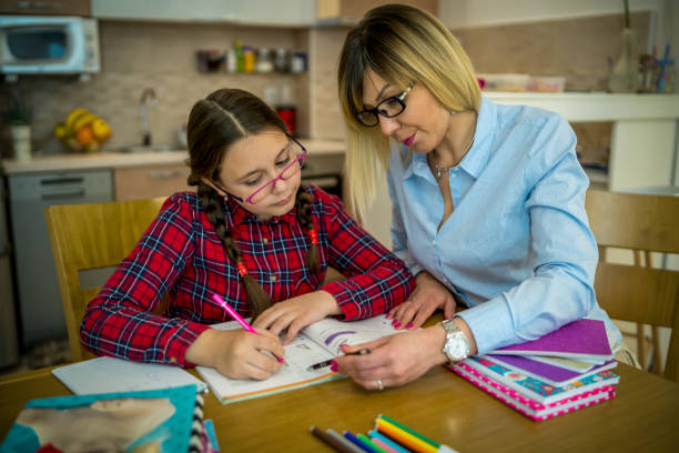 istock Mother and daughter doing homework together 1392161685