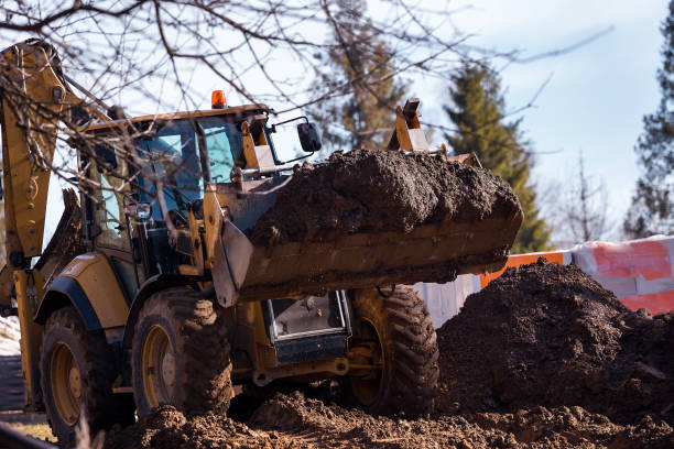 istock The excavator backfills the pit with the front bucket. Moves soil around the construction site. Heavy construction equipment 1392161817
