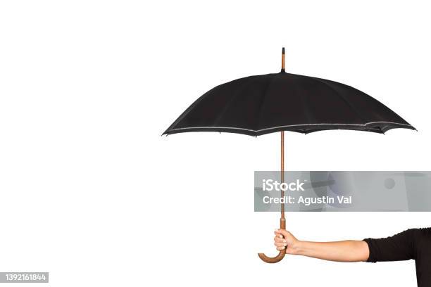 Woman Hand Holding A Black Umbrella On A White Background Stock Photo - Download Image Now