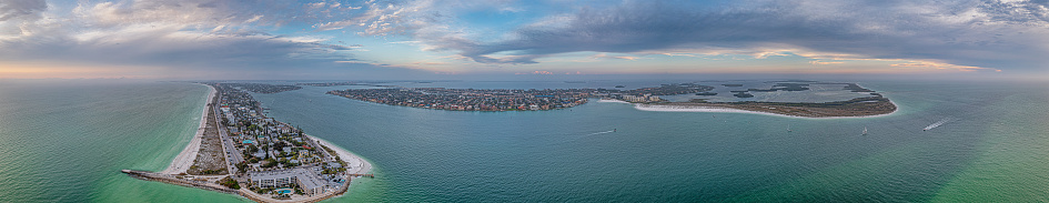 Drone panorama over Pass-a-Grille beach on Treasure Island and Pine Key area in St. Petersburg in Florida during sunset in spring