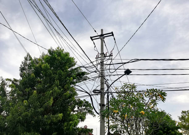 istock Electric cables on the street against sky 1392166418
