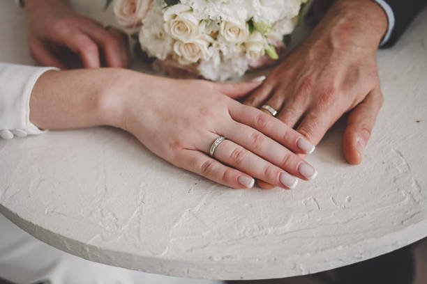 istock hands of the newlyweds. 1392169264