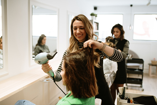 Hairdresser working on a customer's hair in a hair salon