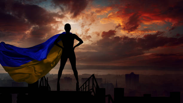 Woman with Ukrainian flag behind her shoulders stock photo