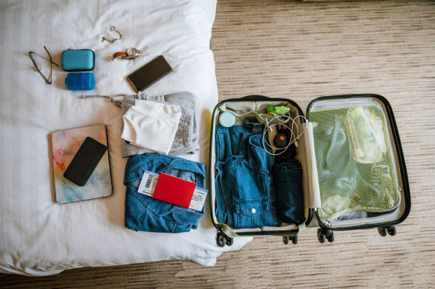 istock Packing suitcase for travel vacation at home 1392171910