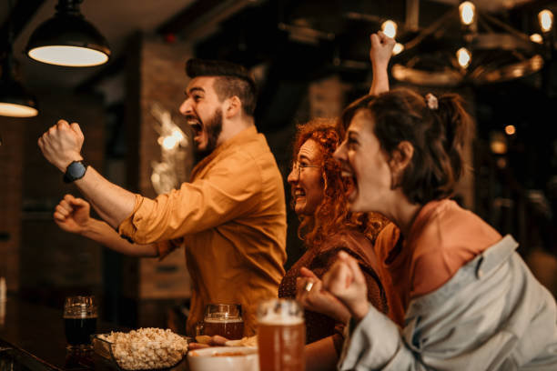 istock Friends cheering sport at bar 1392177350