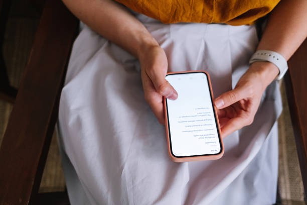 istock Anonymous Woman Texting On Her Mobile Phone 1392180152