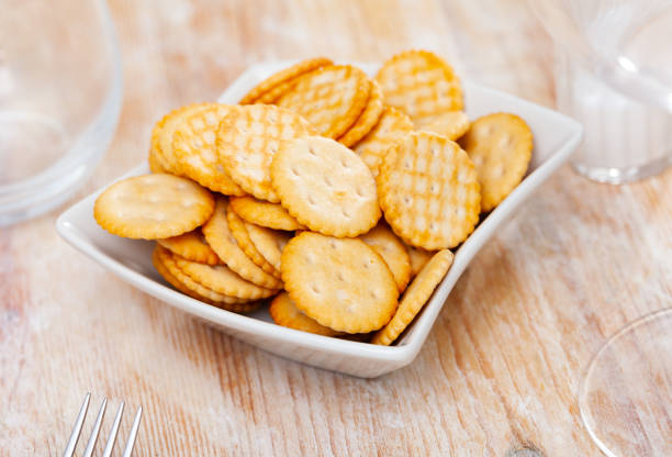 istock Salted crunchy round crackers served on plate 1392180441