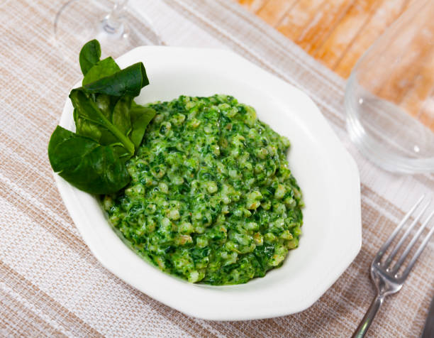 Appetizing vegetarian boiled pearl barley with spinach