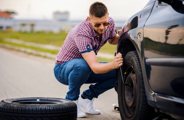 istock Man changing wheel on his car. Transportation, traveling concept 1392183269