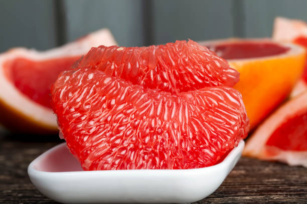 peeled and divided into parts ripe red grapefruit