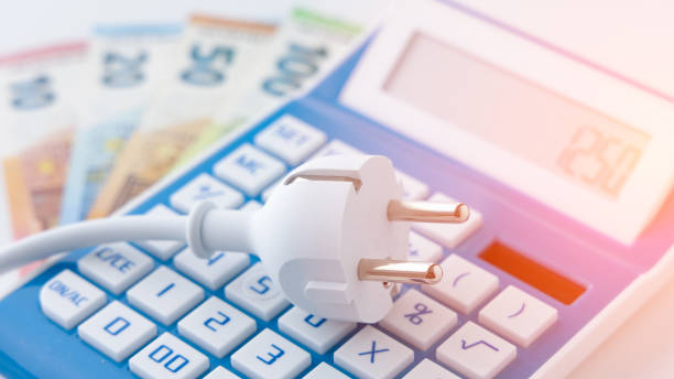 istock Power cord on calculator and euro banknotes 1392185612
