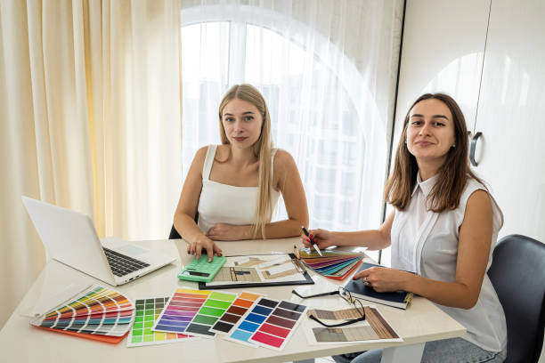 istock two young girls with different color palettes sitting at a spacious table 1392185816