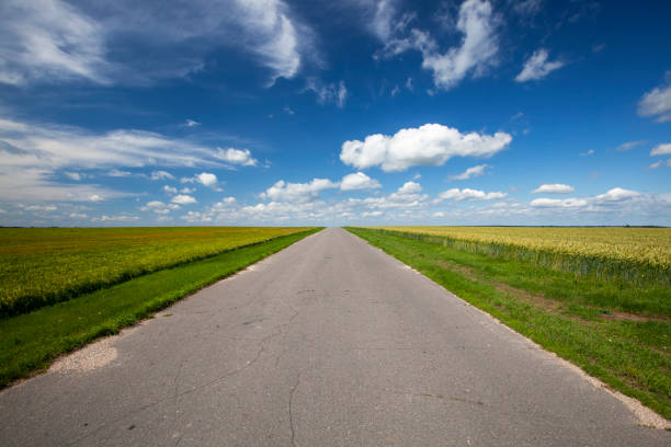 istock paved highway with blue sky and clouds 1392186286