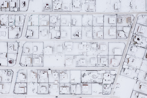 Top view of real cottage village covered by snow in winter. Village plan
