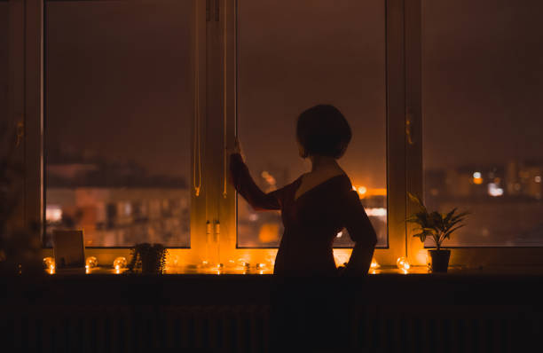 istock Young Woman Looking Out The Window 1392190368