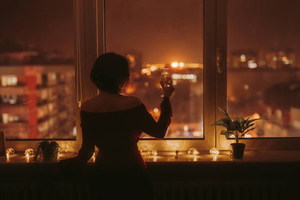 istock Young Woman Looking Out The Window 1392190420
