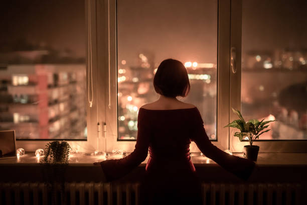 istock Young Woman Looking Out The Window 1392190468
