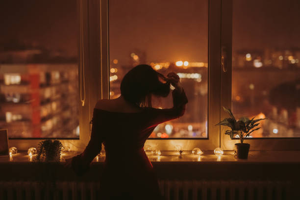 istock Young Woman Looking Out The Window 1392190694