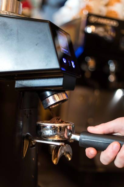 istock Professional Grinding Freshly Roasted Coffee in a Espresso Machine 1392191472