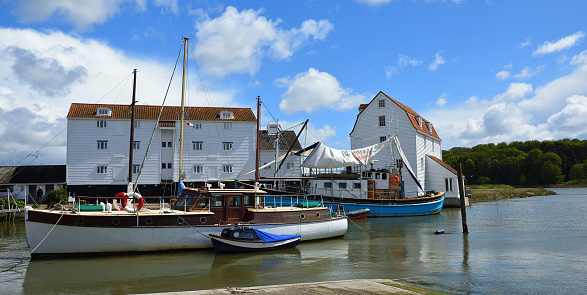 Woodbridge, Suffolk, England - May 04,2019:   River Deben at Woodbridge with Tide Mill and Sailing Barge.