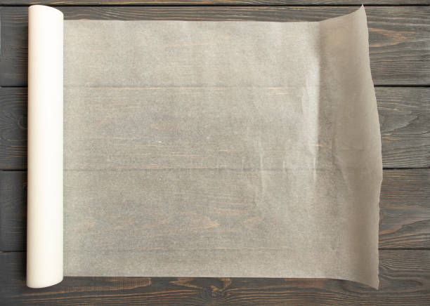 istock Baking paper on wooden kitchen table for menu or recipes, top view 1392192004