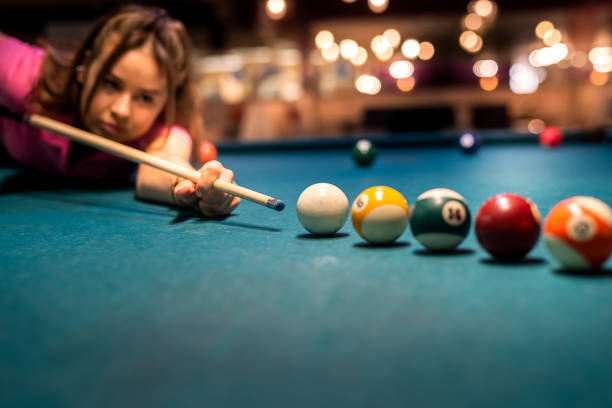 istock pretty lady take to easy shoot to win in billiards game 1392192815