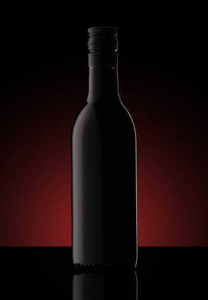 istock a small bottle of wine on a black background 1392194553