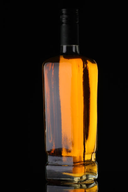 istock full whiskey bottle on black background 1392195864