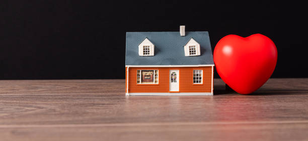 istock Red heart and miniature house 1392195893