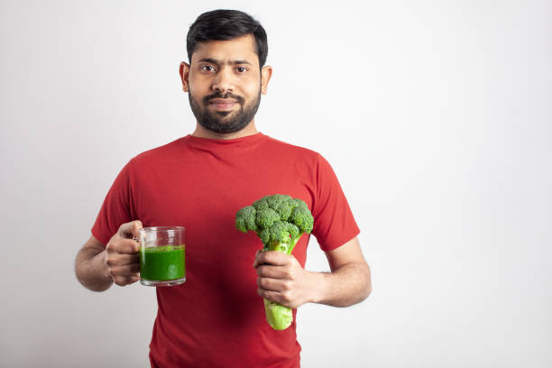 weight loss drink by a healthy fit man healthy eating, keto dieting, fit indian man happy to drink eating body building muscular build vegetable stock pictures, royalty-free photos & images