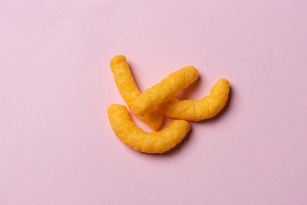istock A few cheese doodles on pink background.. 1392199693