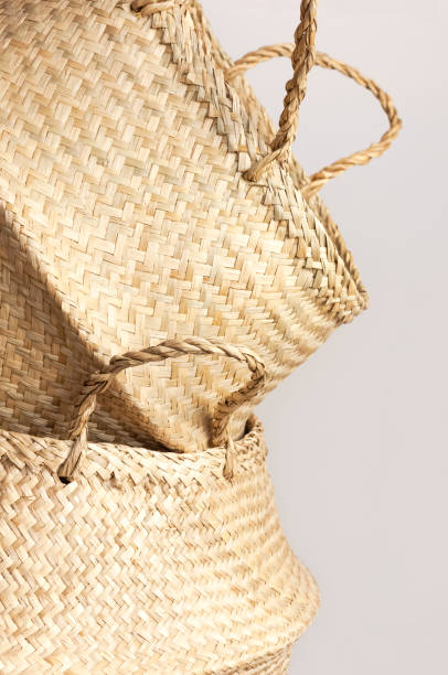 istock Empty straw wicker basket on a gray background. Fashionable bamboo basket, stylish interior item, eco design, handmade. Natural decor of the interior, home. Natural eco materials, storage basket 1392200434