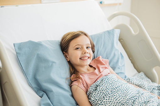Little girl in hospital bed.  Hospital treatment.