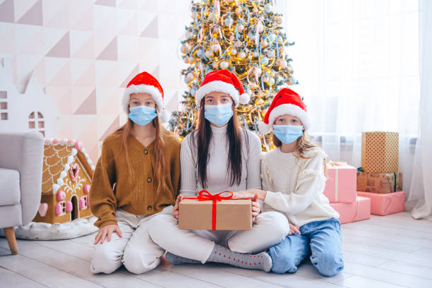 istock Young mom with kids holding christmas presents 1392201825